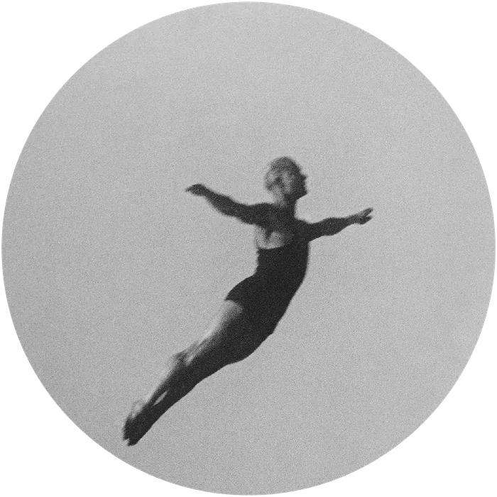 Vintage black-and-white photo of a diver mid-air